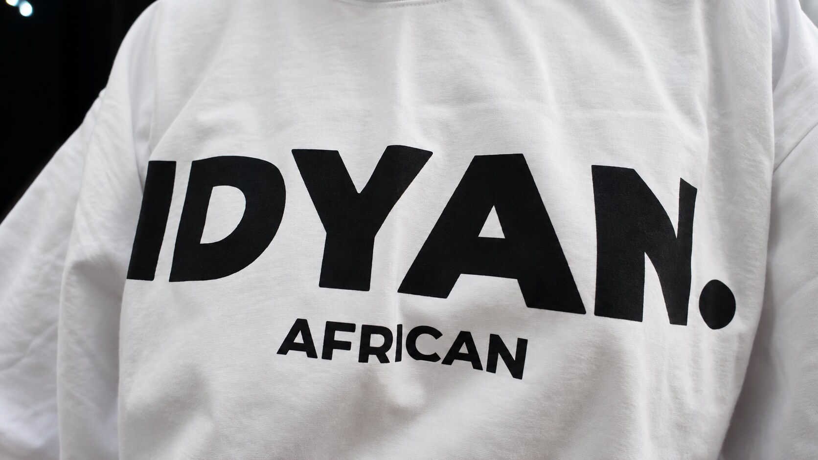 Close-up of the IDYAN. African print on the white tee